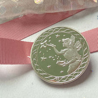 Silver tooth fairy coin next to a personalised tooth fairy letter