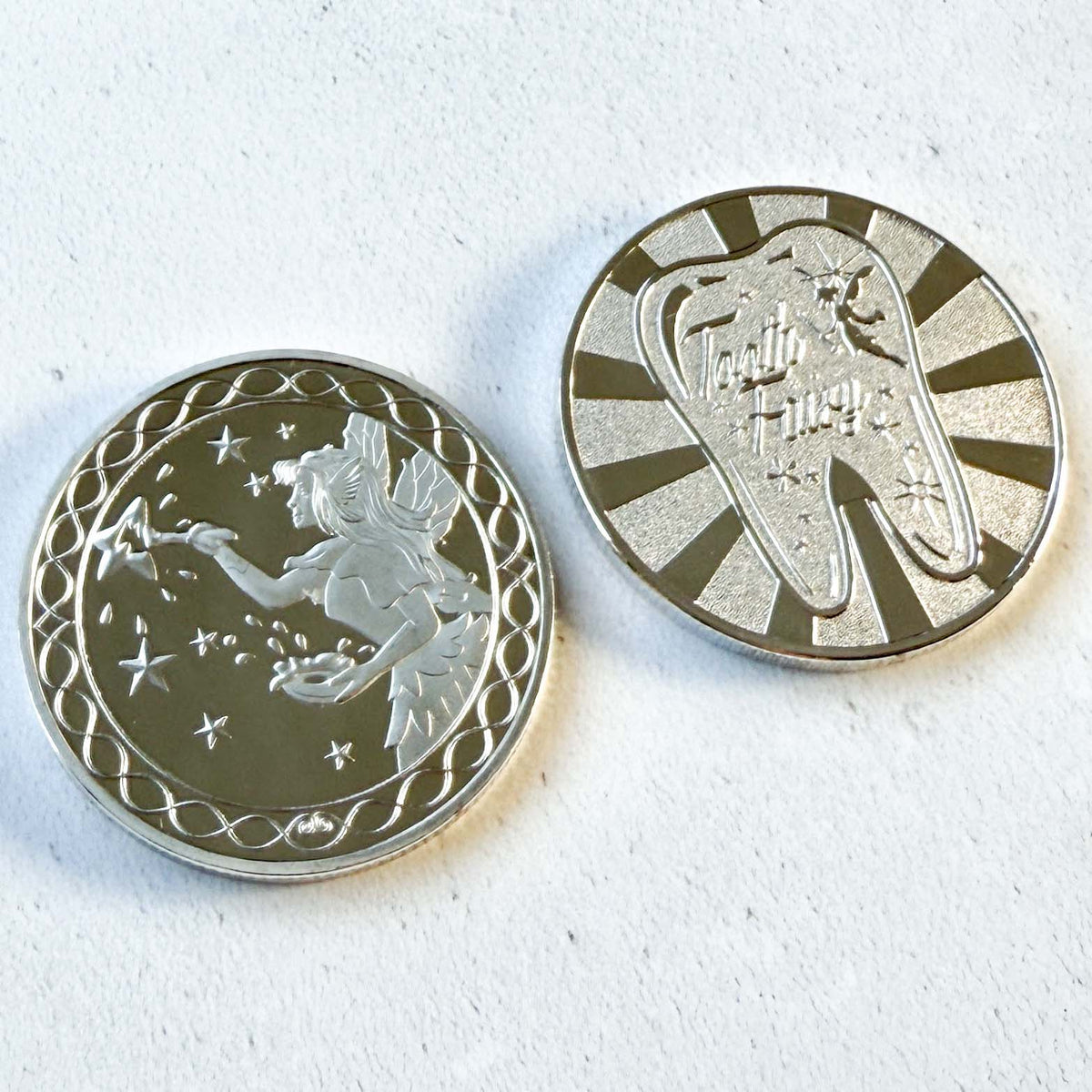 Silver tooth fairy coin showing front design, magical keepsake for children